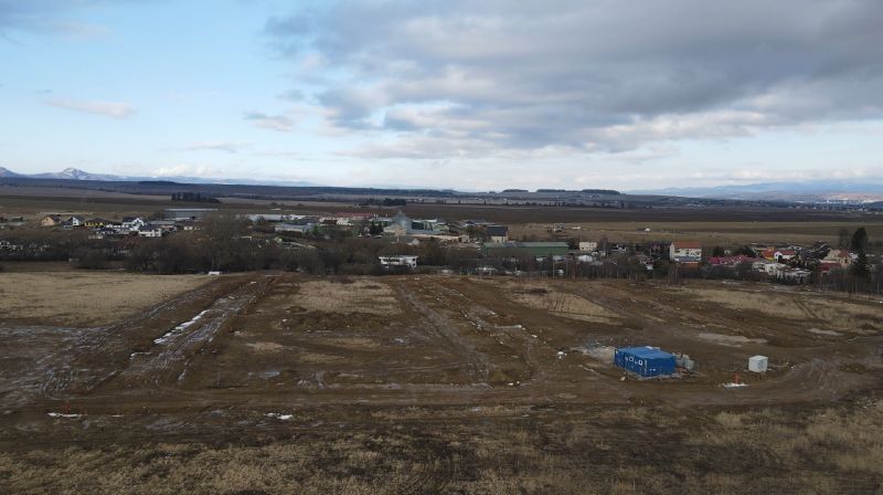Development plots in Mlynica with expansive countryside and partly cloudy skies.