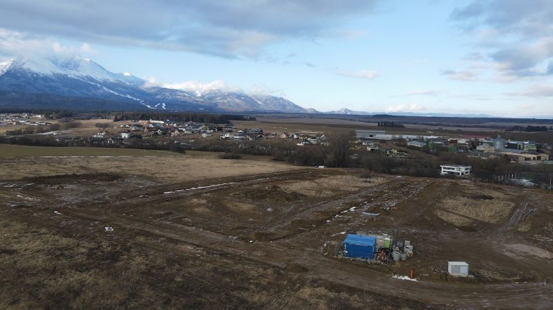 The landscape around Mlynica with a view of development plots and mountain scenery.