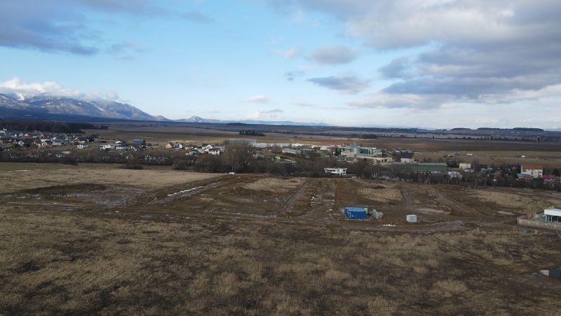 Panorama of development plots in Mlynica, with views of the mountains and rural landscape.