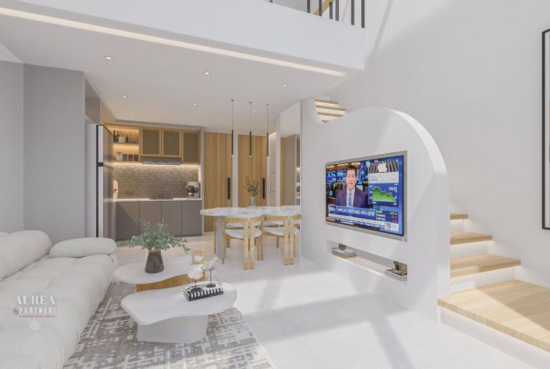 The interior of the villa with a comfortable sofa, television, and a modernly equipped kitchen.