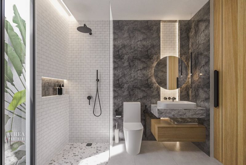Bathroom with stone walls, shower, and sink in a stylish villa.