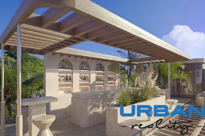 In Nungwi, there is a terrace with a bar in the villa, surrounded by palm trees and greenery.