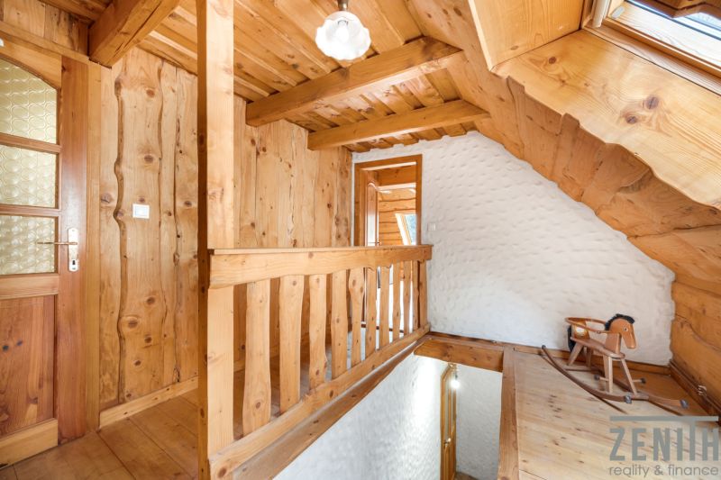 Wooden staircase and wooden paneling in a family house with a swing.