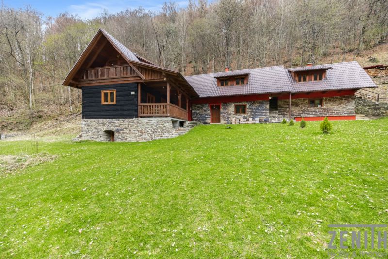 A family house in Horná Mariková with a roof and wooden elements, surrounded by forest.