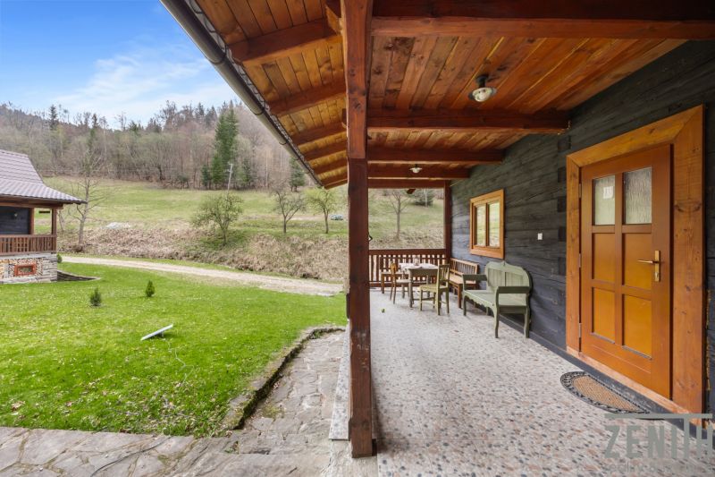The terrace of a family house in Horná Mariková with wooden furniture and a view of nature.
