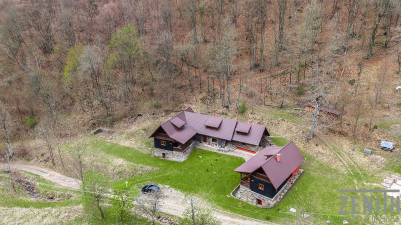 An aerial view of a family house in Horná Mariková, surrounded by an autumn forest.