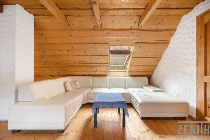 White corner sofa with a coffee table on a wooden-decor floor, family house.