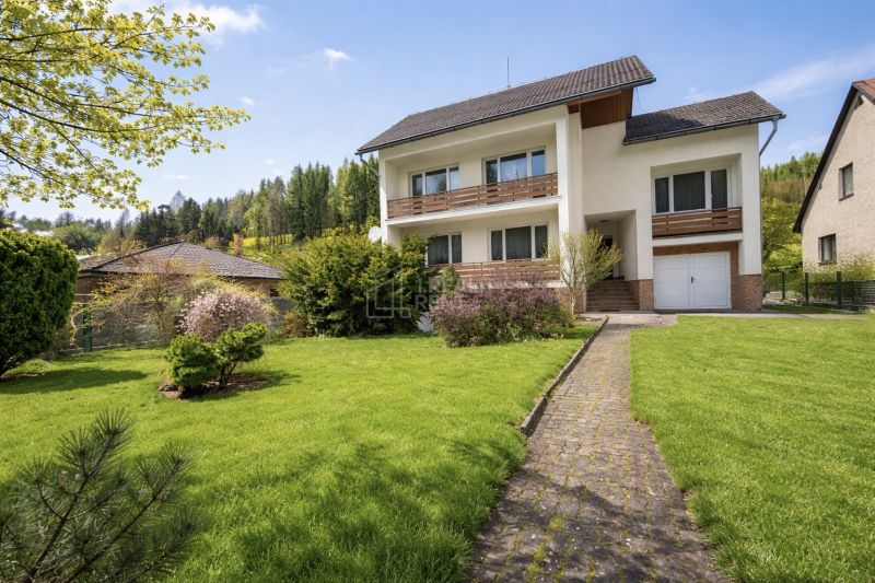 A family house on Čadečka Street in Čadca, surrounded by a beautiful garden and an access walkway.