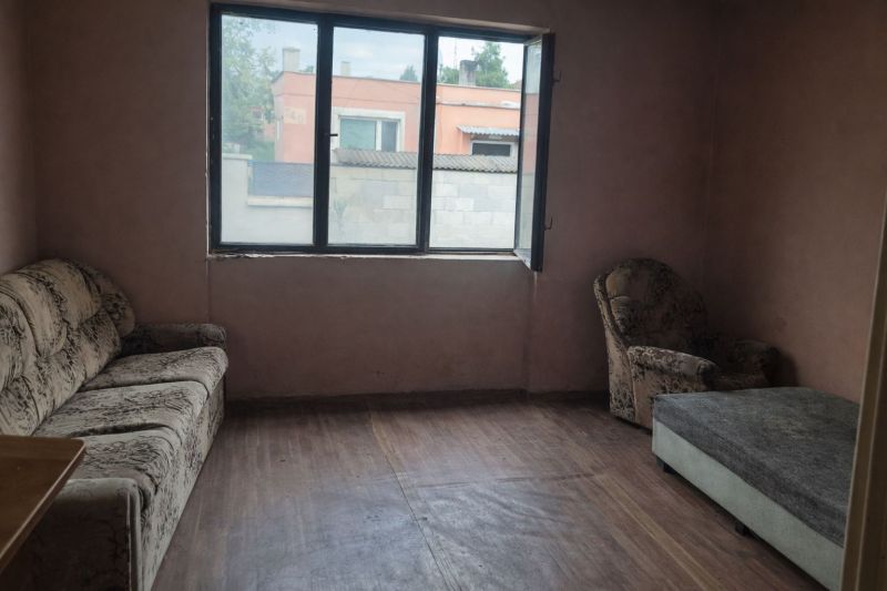 A room with vintage furniture and a wooden decor floor in a family house.