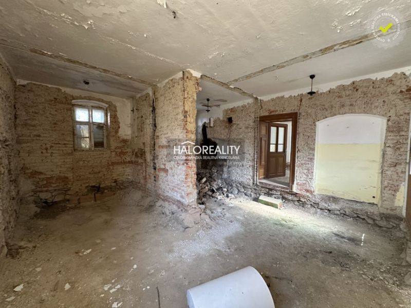 The interior of a family house with wooden decor, a comfortable sofa, and a dining table.