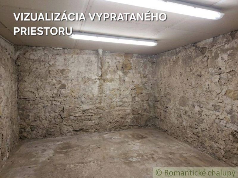 Stone walls and a concrete floor in the basement of a family house.