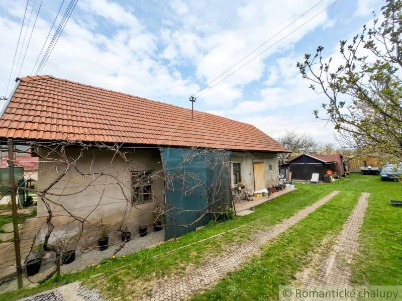 A family house in Stožok with a red tiled roof and greenery in the yard.