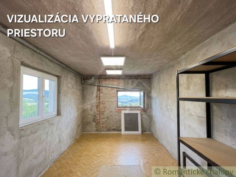 A room with a wood-patterned floor and unfinished walls in a family house.