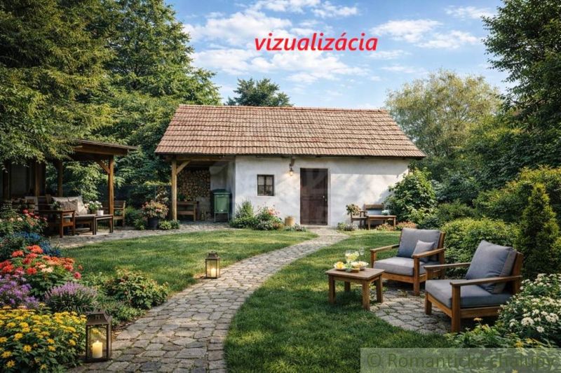 A garden with a cottage in Šahy surrounded by flowers and outdoor seating.