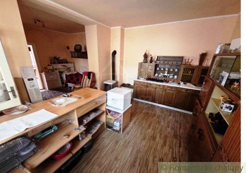 Interior of a family house with wooden decor, cabinets, and rustic furniture.