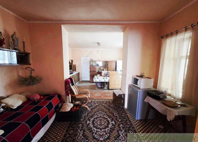 Interior of a family house with carpets, decorative items, and furniture.