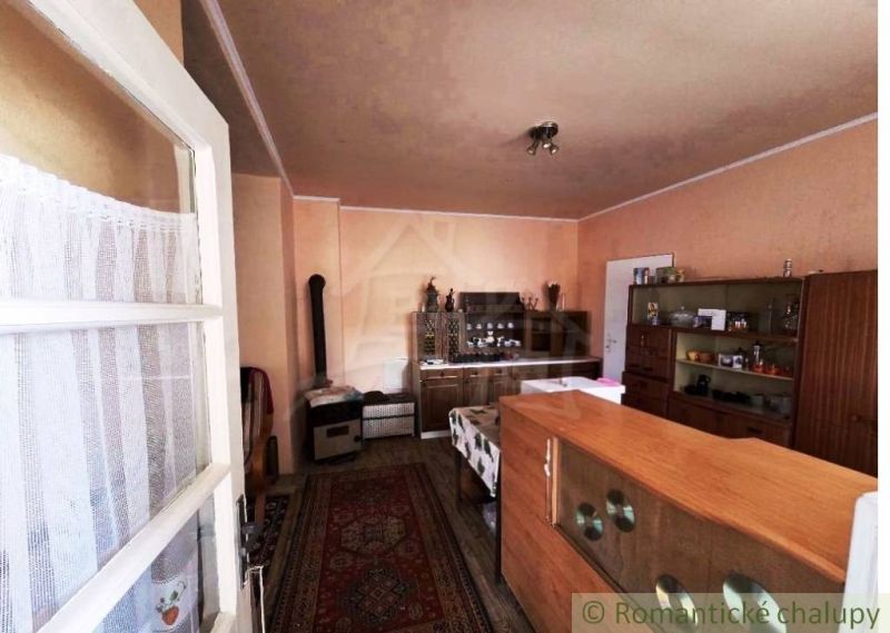 Living room in a family house with carpet and furniture, floor with wooden decor.