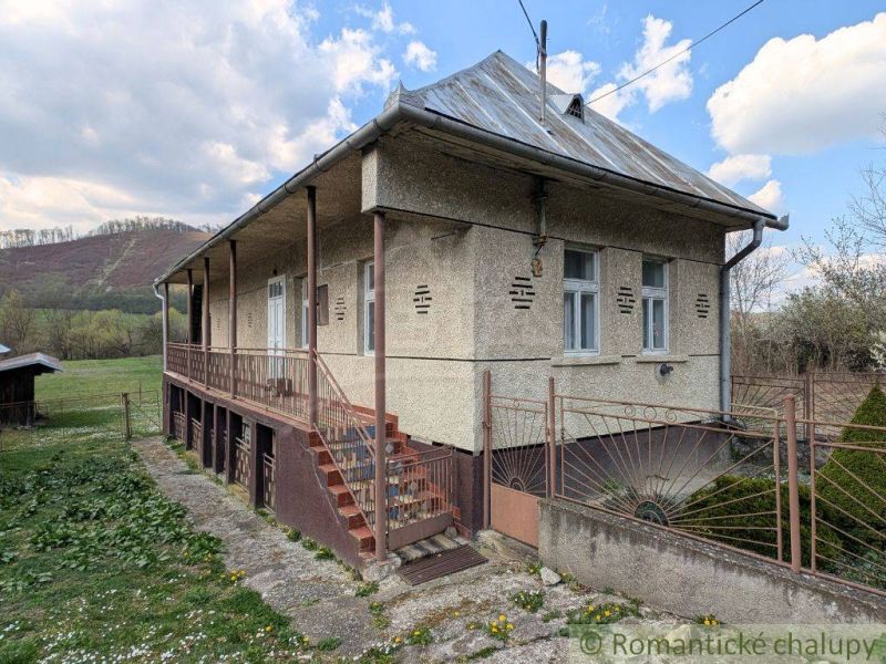 A family house in Zubné with a veranda and stairs in a natural setting.