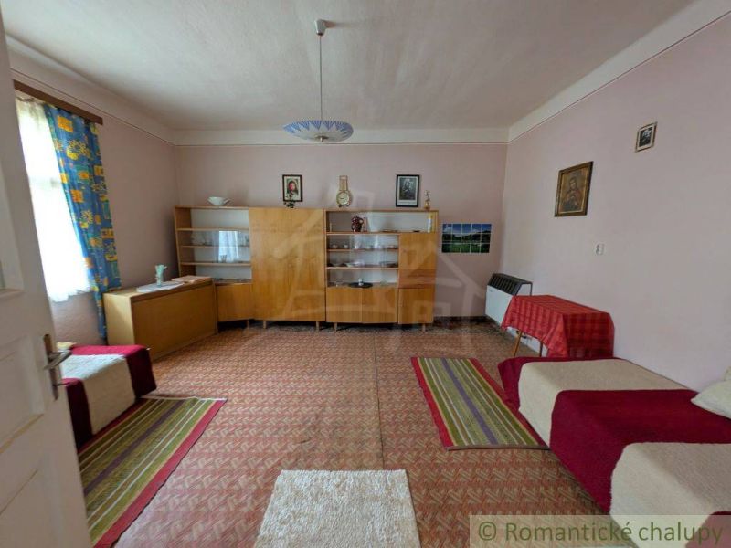Living room in a family house with antique furniture, multicolored carpets.