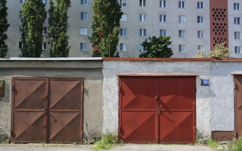 Garages on Varšavská Street in Bratislava - Nové Mesto, residential building in the background.