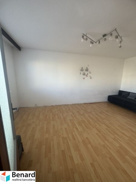 Installed lighting, sofa, and wood-patterned flooring in a 3-room apartment.