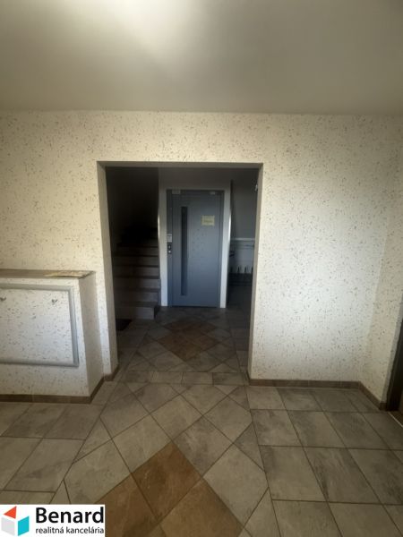Entrance hall with staircase and elevator in an apartment building on Mierová Street in Stará Ľubovňa.