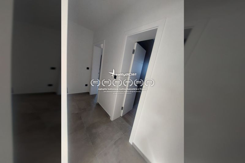 Interior of a holiday apartment with white walls and a floor with a wood decor.