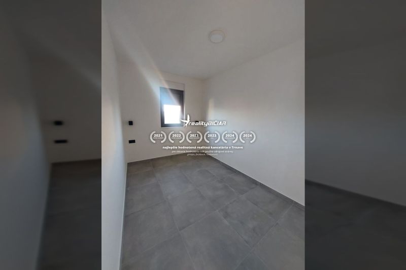 Room with tiles and a window in a recreational apartment.