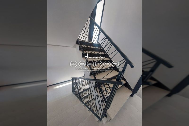 Staircase with metal railing and floor with wooden decor in a Holiday Apartment.