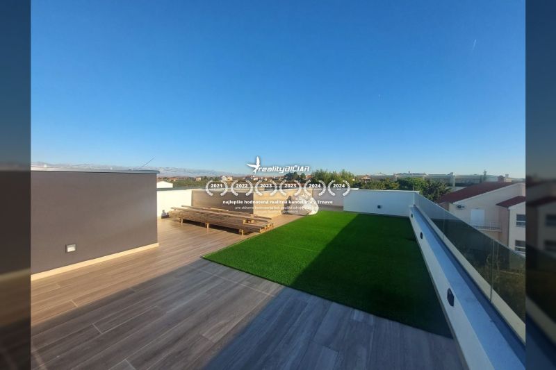 A terrace with a wooden decor floor in a holiday apartment in Privlaka, Privlaka.