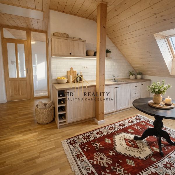 Attic kitchen in a family house with a wooden decor floor and carpet.