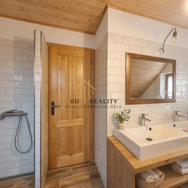 Bathroom in a family house with white tiles and a mirror.