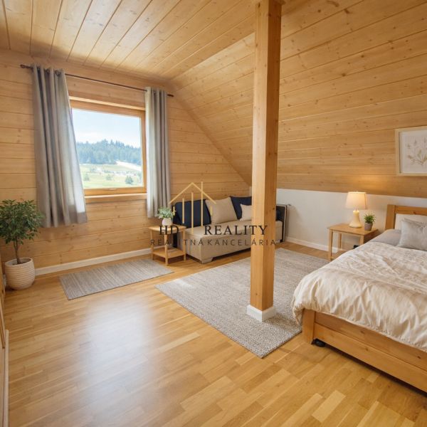 Bright bedroom in a family house with wood-decor flooring and a well-lit interior.