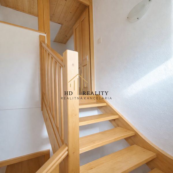 Interior of a family house with a wooden staircase and flooring with a wooden decor.