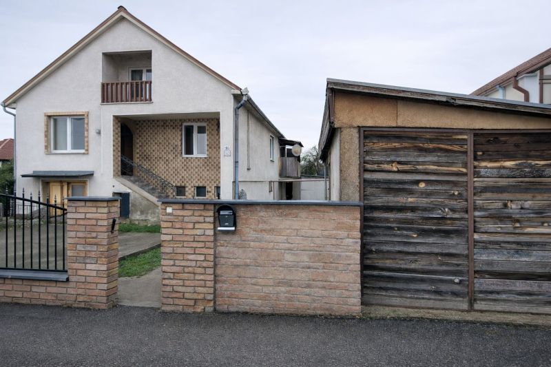 A family house on Antona Bernoláka Street in Kolárovo, with a separate wooden garage next to it.