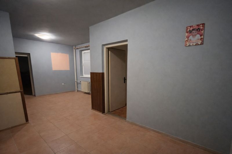 The interior of a family house with tiles, light walls, and open space.