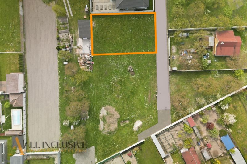 Aerial view of residential plots in Rohovce, green parcels with neighboring buildings.