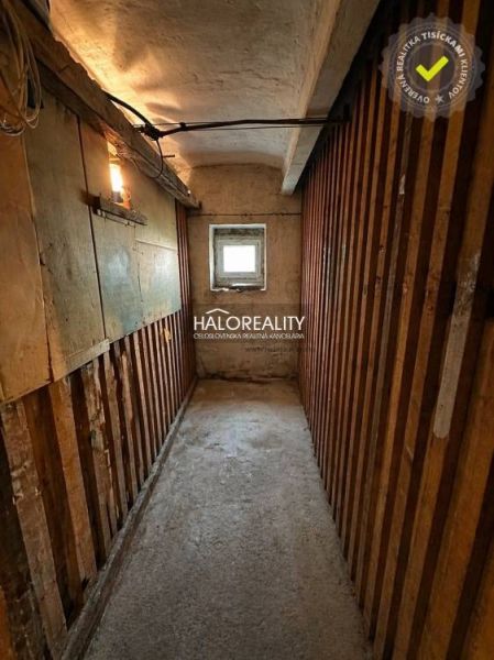 Interior with brick-patterned wallpaper and wood-decor flooring, studio apartment.