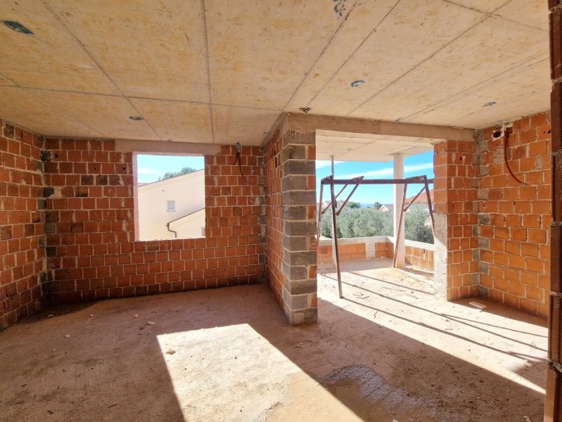 Unfinished room with open walls in a 3-room apartment without flooring with wooden decor.