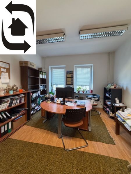 Offices with wooden floor decor, green carpet, and a large window.