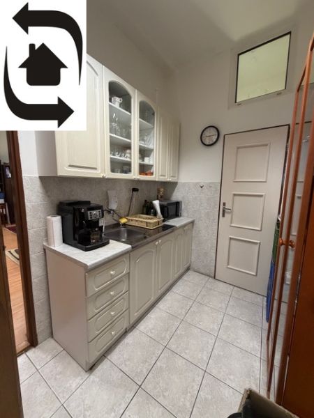 Offices with a coffee machine and white cabinets, tiles, next to the kitchen.