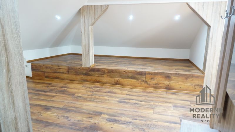 Attic room in a 4-room apartment with a wooden decor floor.
