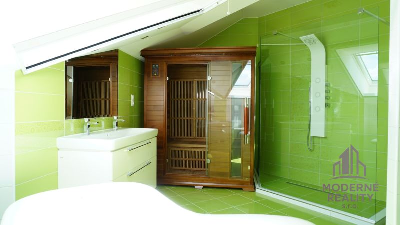 Green and white bathroom with a sauna in a 4-room apartment.