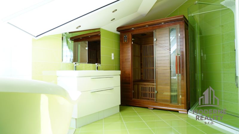 A bathroom in a 4-room apartment with a sauna and green tiles.