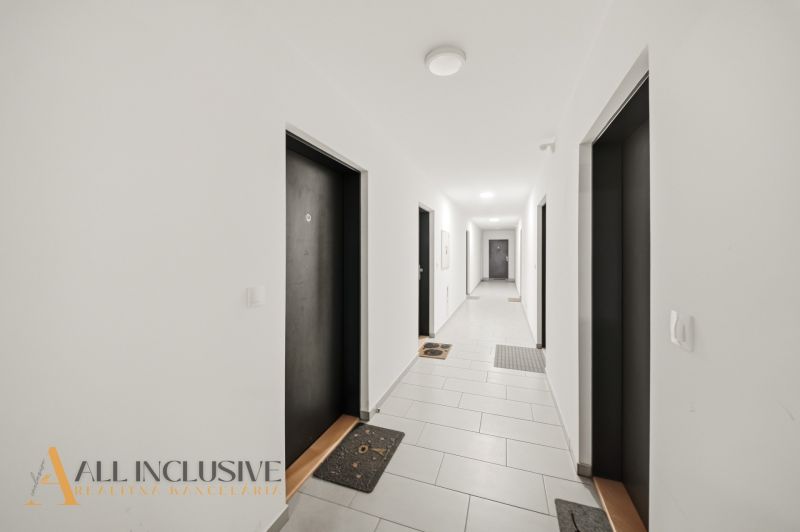 A corridor with white walls and doors in a building on Zuzany Chalupovej, Bratislava - Petržalka.