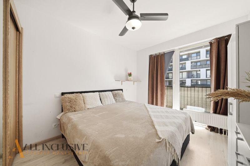 A bright bedroom with a large bed in a 2-room apartment, overlooking the terrace.