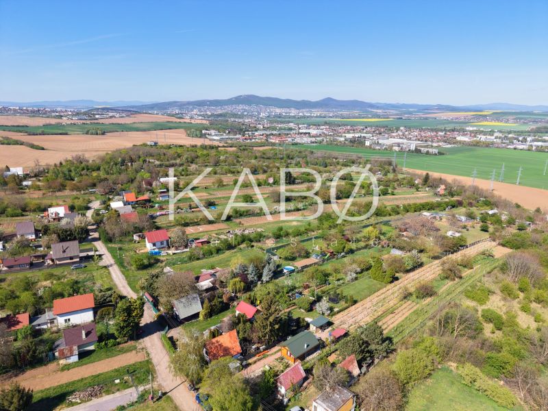 Country cottages around Nitra, surrounded by fields and greenery with views of the hills.