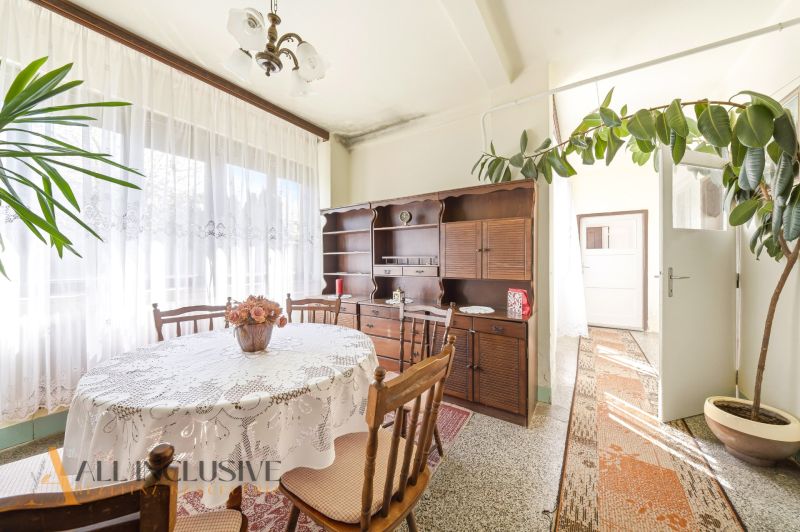 Dining room with wooden furniture and decor in a family house, bright atmosphere.