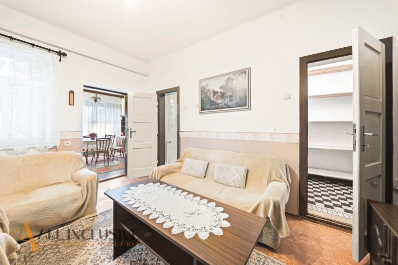 Living room in a family house with sofas, a table, and a picture on the wall.