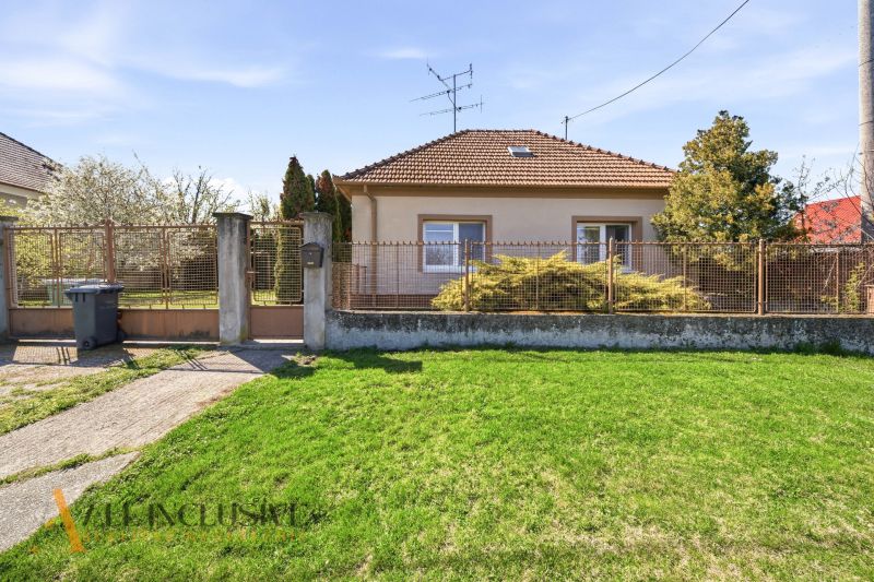 A family house in Vydrany near Dunajská Streda with a front garden and a metal fence.